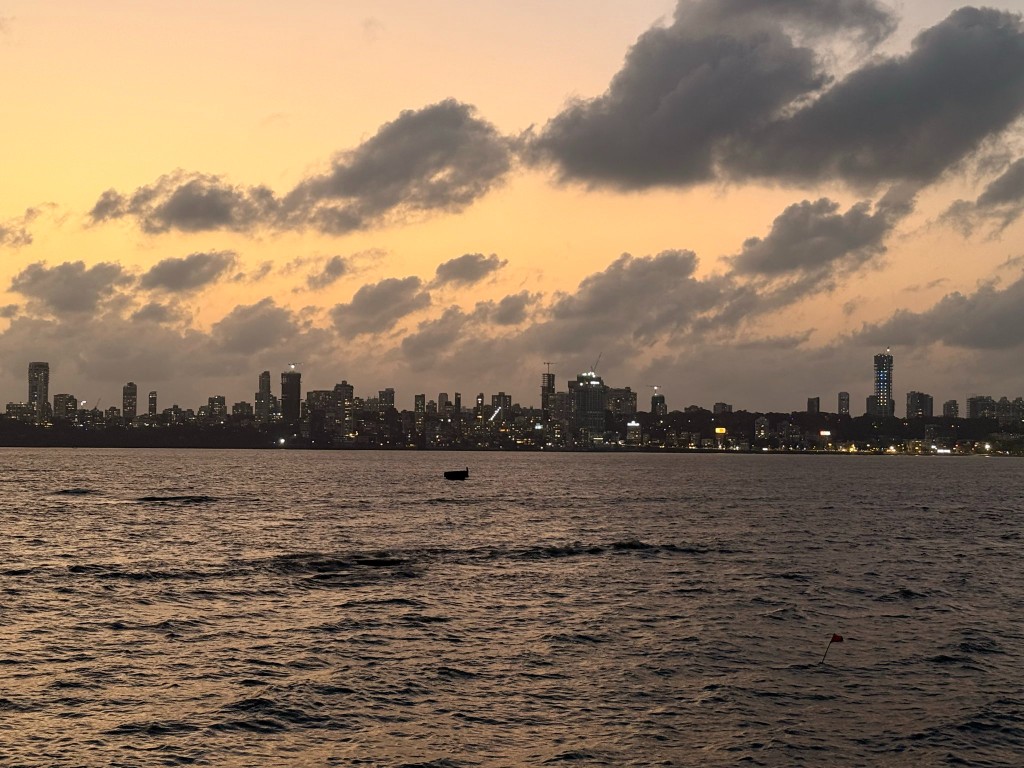 Mumbai skyline across the water at dusk